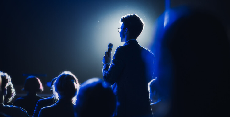 A speaker talking at a business confernce